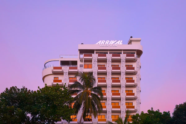 Arrival Beach & Spa, a tall hotel building on Gulhi, at dusk