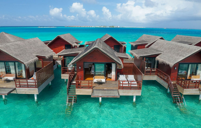Lagoon Water Villas at Grand Park Kodhipparu, timber villas with decks and steps down into turquoise water
