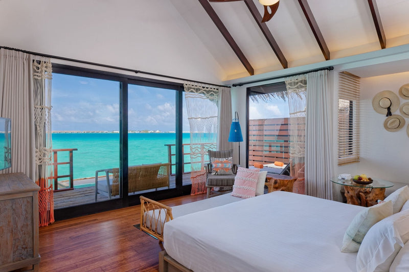 A Lagoon Water Villa bedroom at Grand Park Kodhipparu, looking out to the ocean