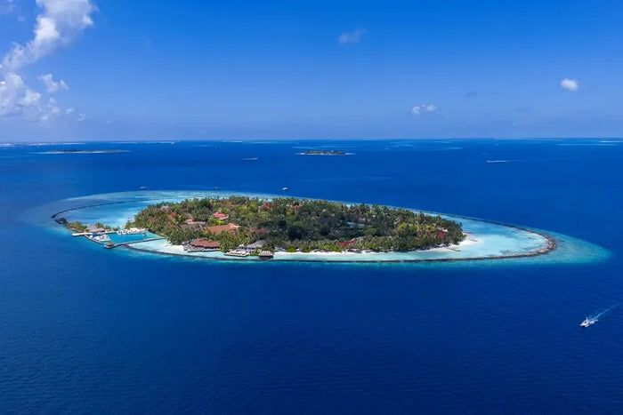 Niva Kurumba Maldives from the air, the island in deep blue ocean, North Malé Atoll