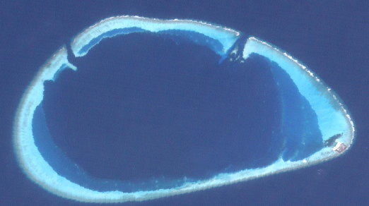 Gaafaru Atoll seen from space, an oval ring of reef with the island of Gaafaru at its south-eastern tip