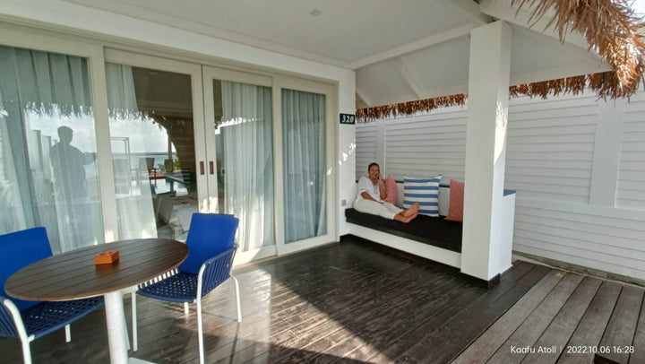 Amosha lounging by the cushy recliner in the beach villa