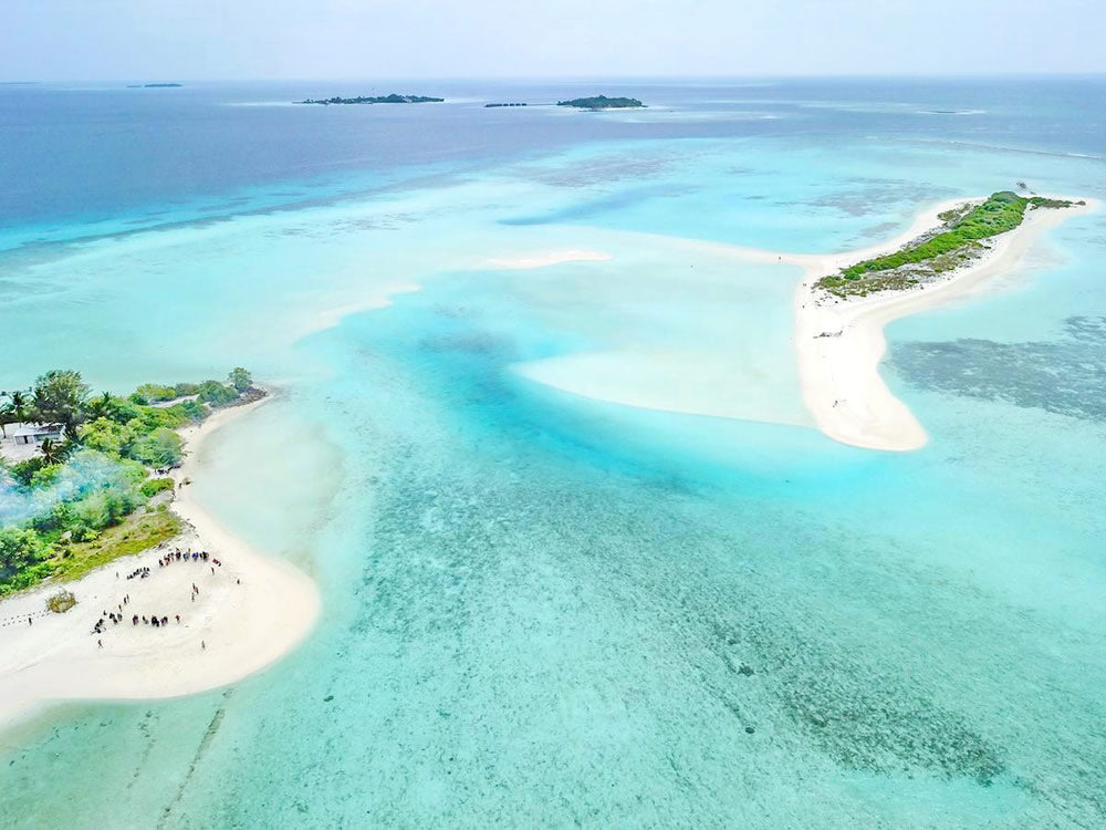 Mathiveri Finolhu, the sandbank picnic island off Mathiveri, seen from the air across a shallow turquoise lagoon