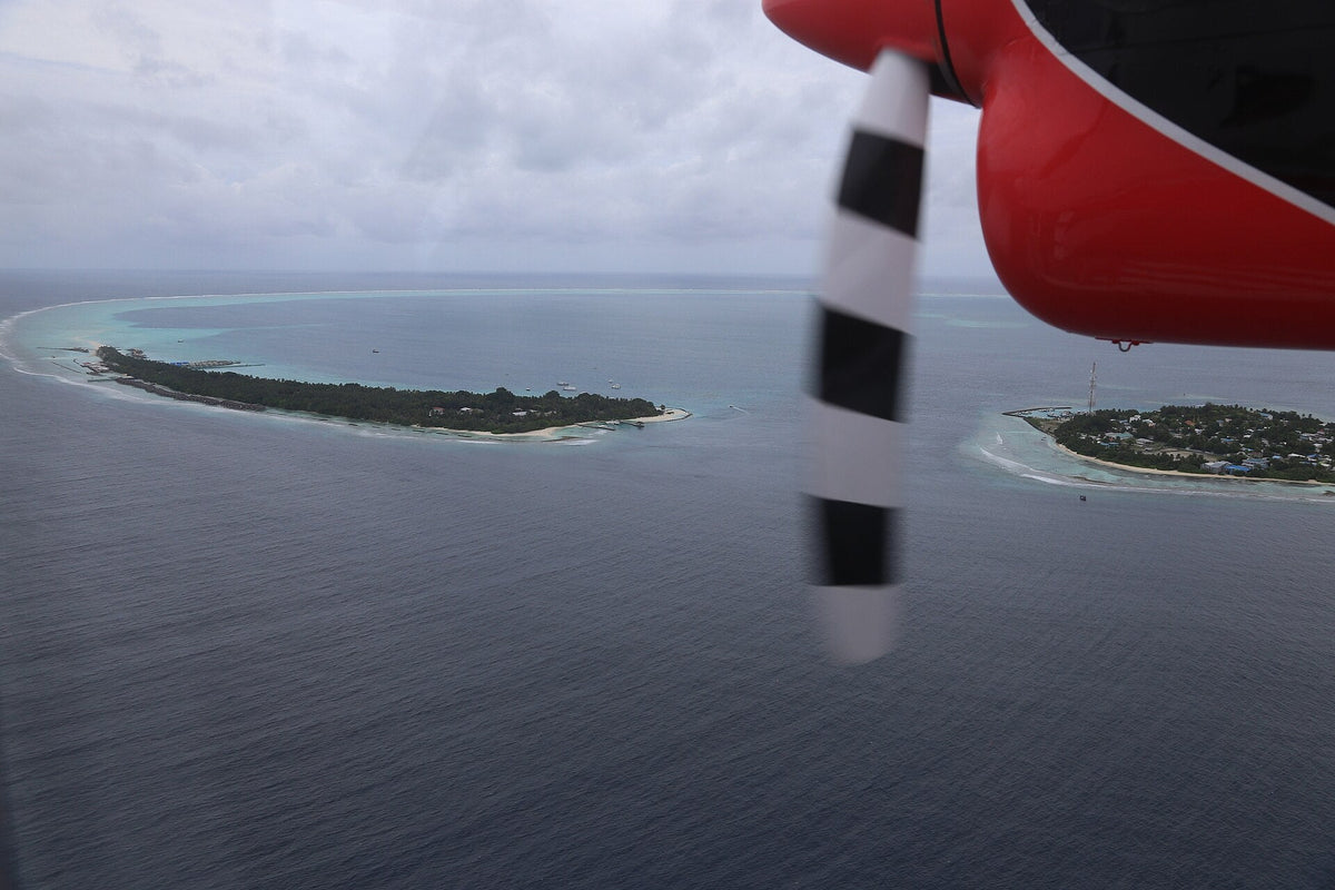 Rasdhoo and Kuramathi from the air, two green islands ringed by white sand in the small Rasdhoo Atoll