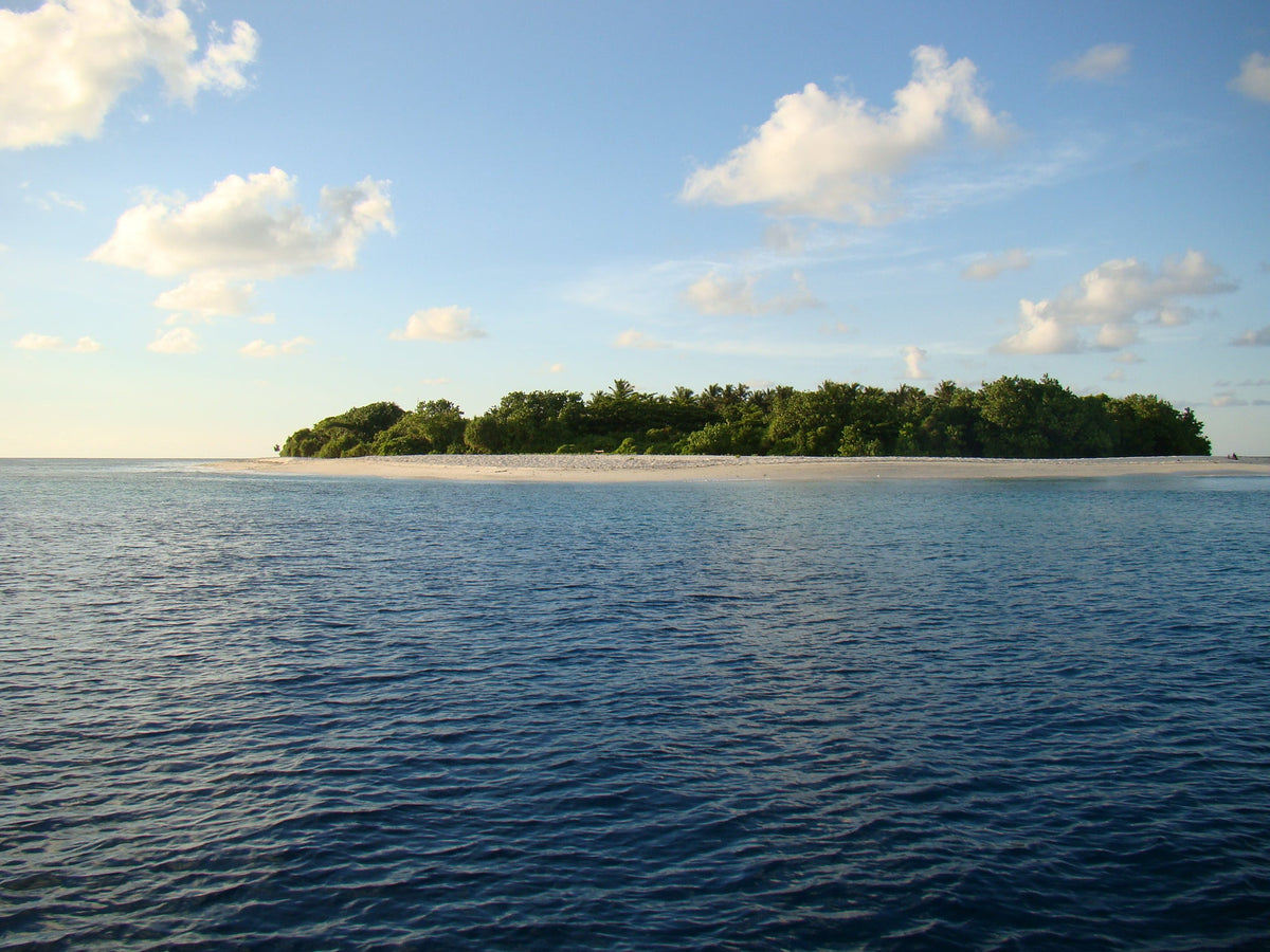 Ukulhas seen from the sea, a green island ringed by white sand