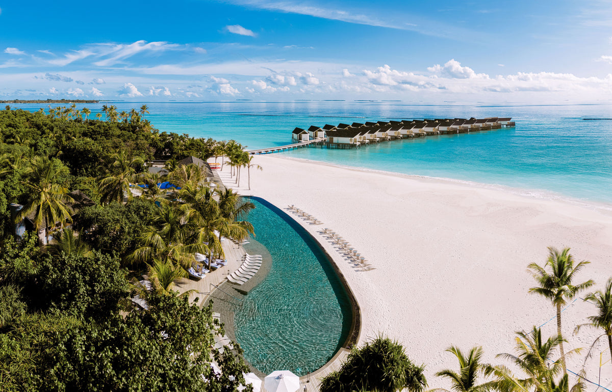 RAAYA by Atmosphere, Raa Atoll, from the air: the main pool beside the beach, with the water villas beyond