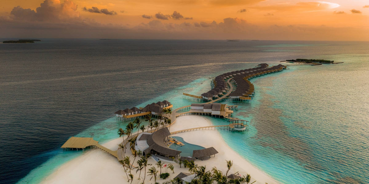 Sun Siyam Vilu Reef, Dhaalu Atoll, from the air, with its overwater villas curving into the lagoon