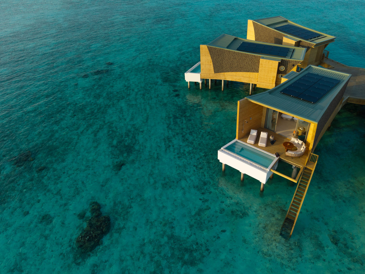 Overwater villas with plunge pools at Centara Mirage Lagoon Maldives, above the reef lagoon.