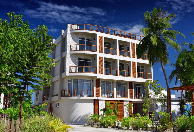 Velana Beach Hotel seen from the street, with balconies on every floor