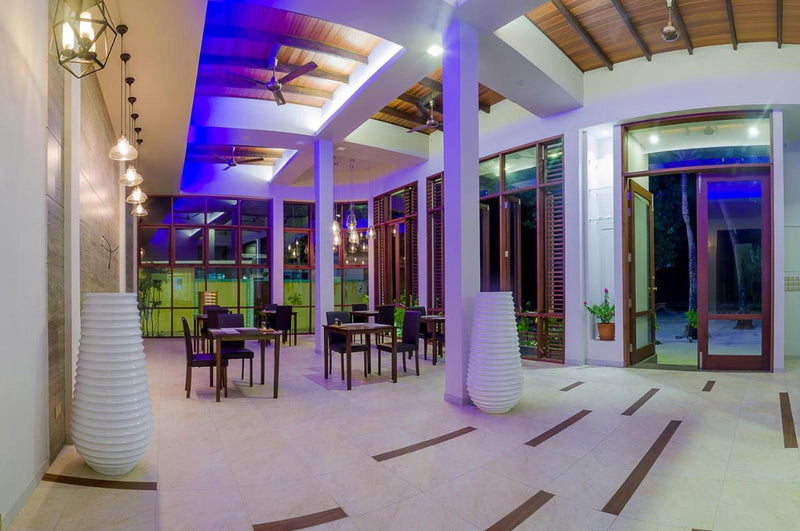 Dining area at Velana Beach Hotel in the evening