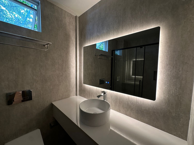 Bathroom at Cozy Nest Fuvahmulah with a vessel basin under a backlit mirror