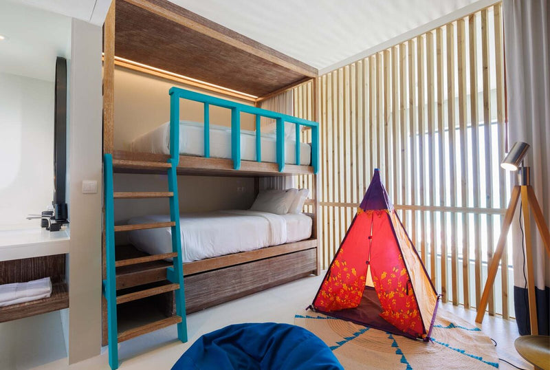 A children's room at Hard Rock Hotel Maldives, bunk beds with a play tent alongside.