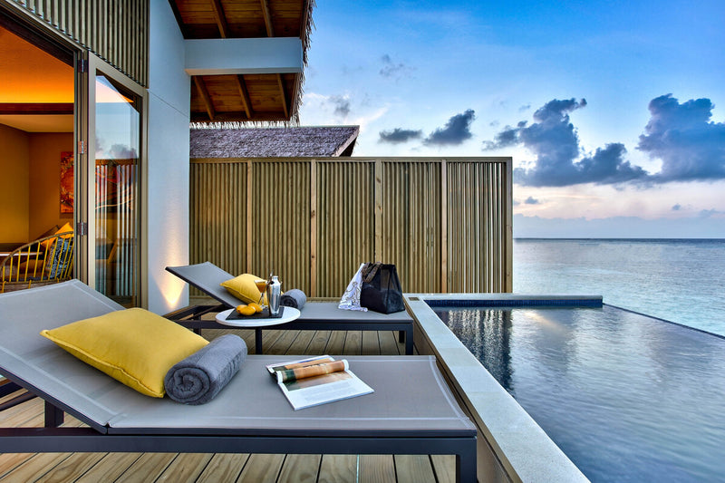 The deck of a Platinum Overwater Pool Villa at Hard Rock Hotel Maldives, a sun lounger beside the plunge pool.