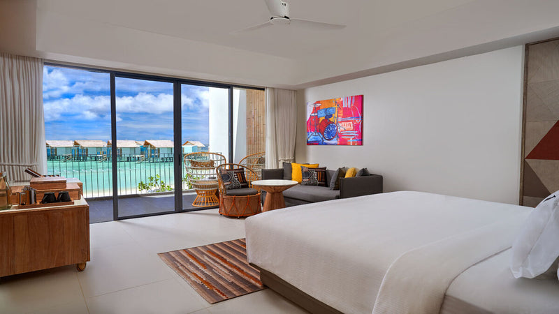 A Silver Sky Studio at Hard Rock Hotel Maldives, twin beds and a balcony over the water.