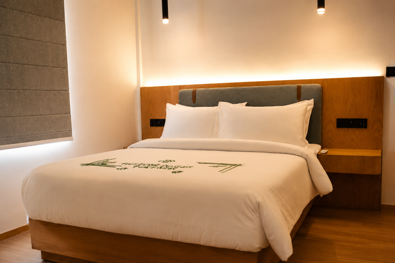 Room at Cozy Nest Fuvahmulah with a double bed under a lit timber headboard