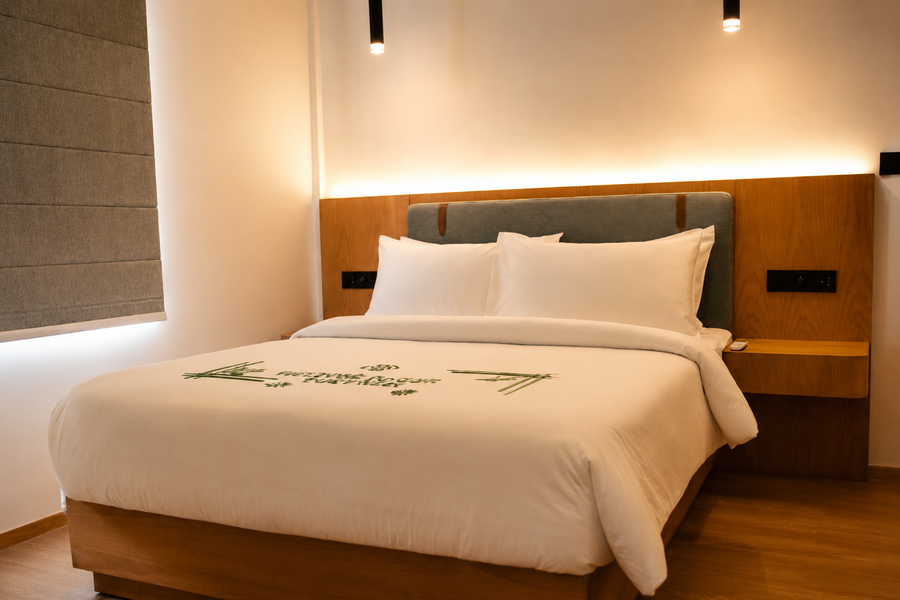 Room at Cozy Nest Fuvahmulah with a double bed under a lit timber headboard