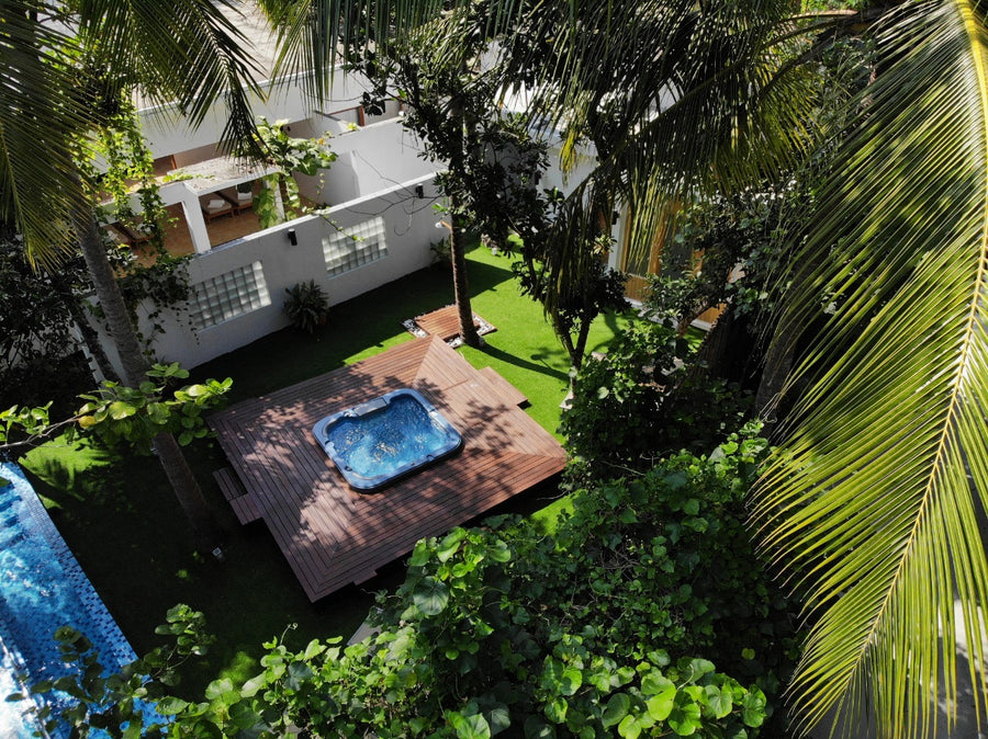 A beach villa with a pool at Cocoon Maldives from the air.