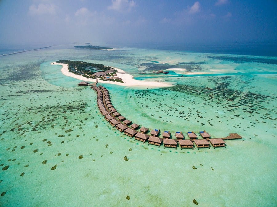 Cocoon Maldives from the air, the island and its row of overwater villas