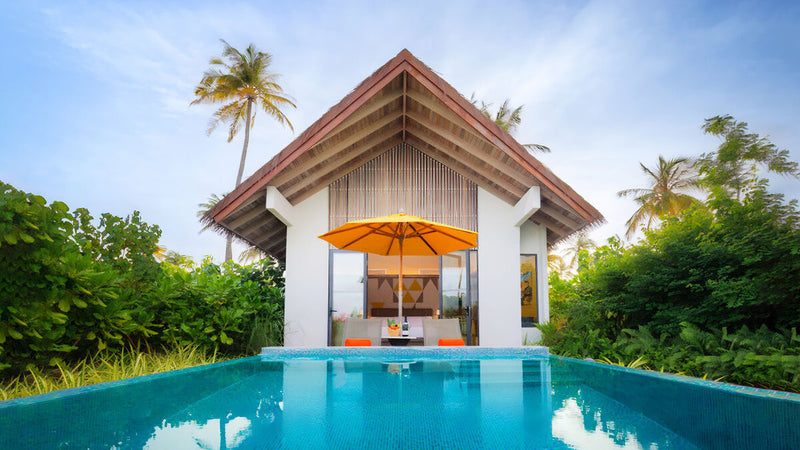 A Gold Beach Pool Villa at Hard Rock Hotel Maldives, its plunge pool and parasol under the palms.