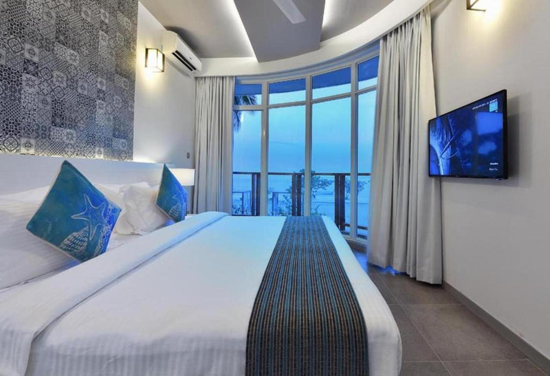 Double room at Velana Beach Hotel with full-height windows onto the sea