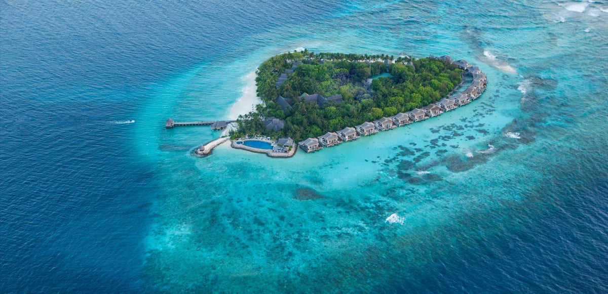 Taj Coral Reef Resort & Spa, Maldives from the air, the island inside its reef.