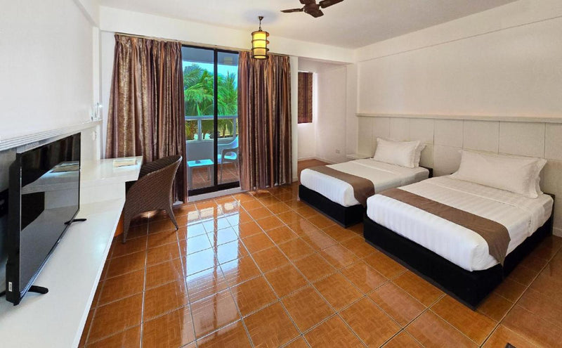 Twin room at Rashu Hiyaa with two beds and a balcony door