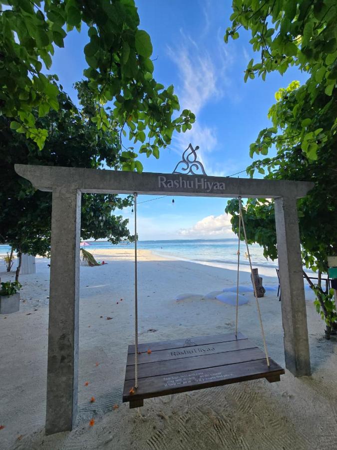Wooden gateway with a swing opening onto the beach at Rashu Hiyaa