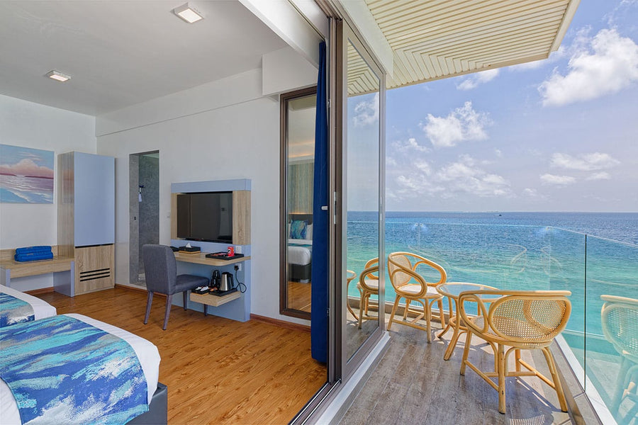 Room at Arena Beach Hotel opening onto a balcony with sea views