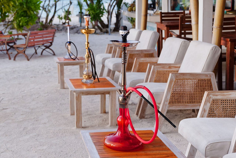 Beachfront terrace with loungers and tables at Arena Beach Hotel