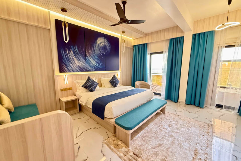The Arrival Suite, with a king bed and windows along one wall