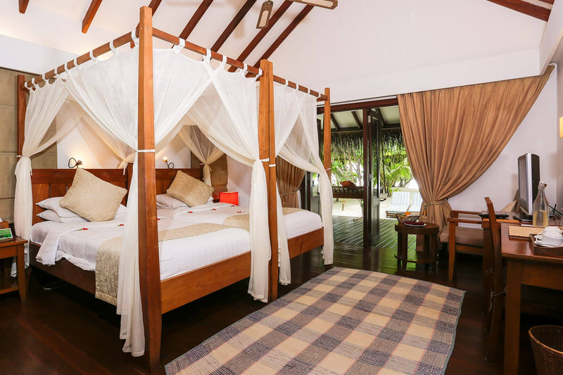 Four-poster bed in a Beach Villa Suite at Medhufushi Island Resort