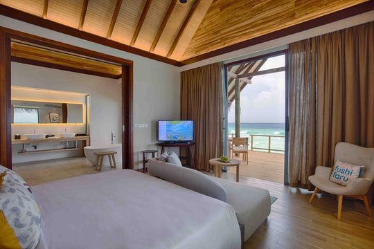 Fushifaru Maldives, Lhaviyani Atoll — villa interior lined in timber, with a king bed