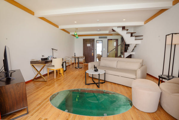 The living area of a duplex villa at NOOE Maldives Kunaavashi.