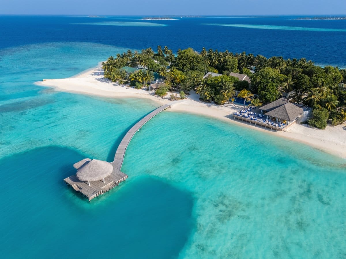 The jetty at Eri Maldives from the air, running from the beach into the lagoon.