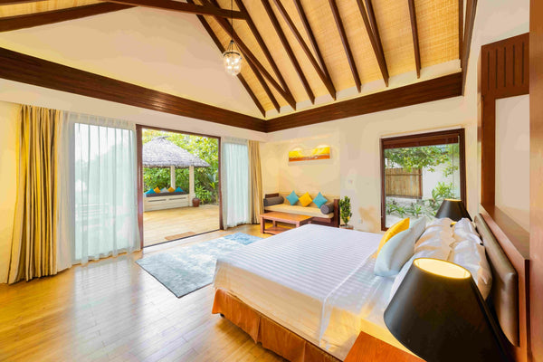 Interior of a Beach Villa at Furaveri, timber ceiling and doors open to the garden