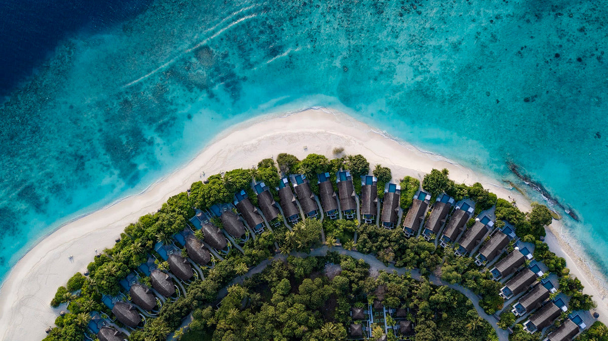 Furaveri Maldives from the air, the island tip, beach villas and white sand.