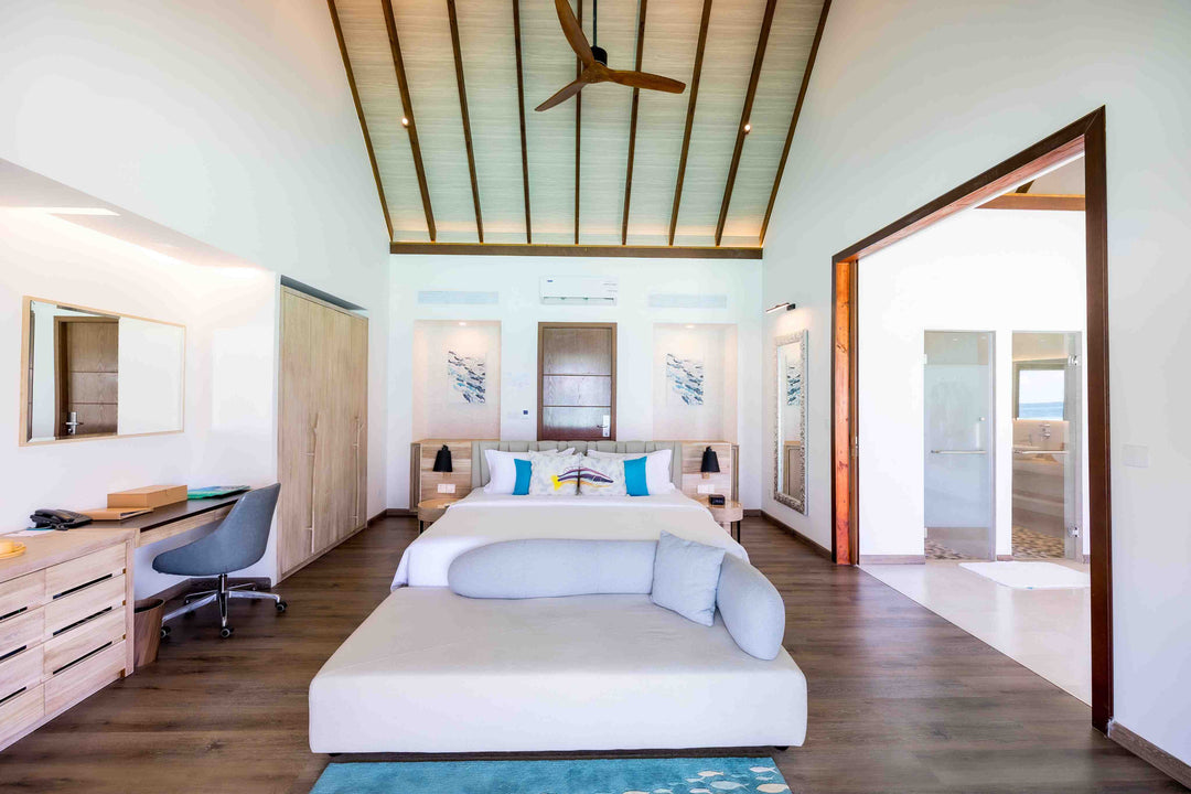 Fushifaru Maldives, Lhaviyani Atoll — villa bedroom opening to daylight and the sea beyond