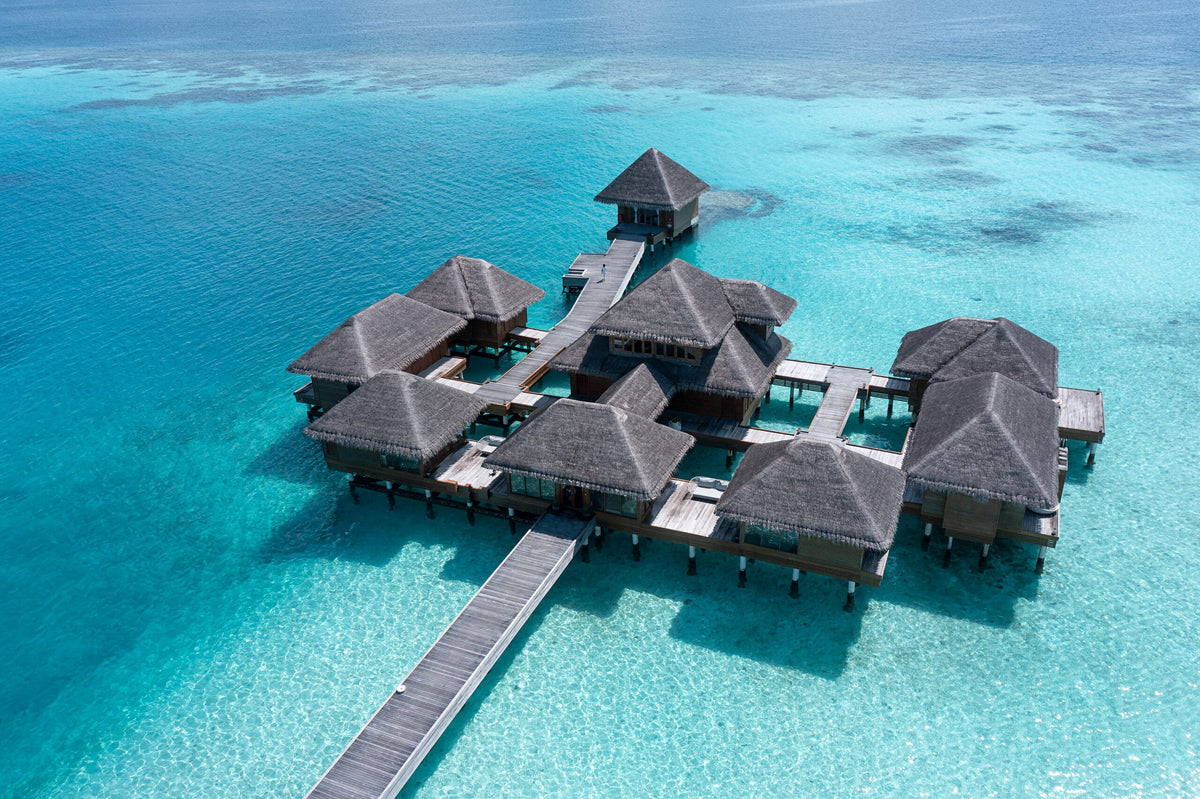 The overwater pavilions at Huvafen Fushi from the air, above the lagoon.