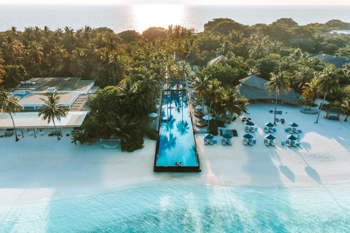 The long pool at Sirru Fen Fushi Private Lagoon Resort running down through the palms to the beach