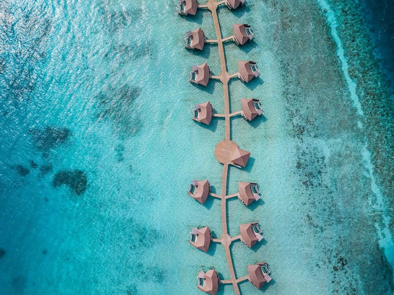 InterContinental Maamunagau from above, two rows of overwater villas along a central jetty.