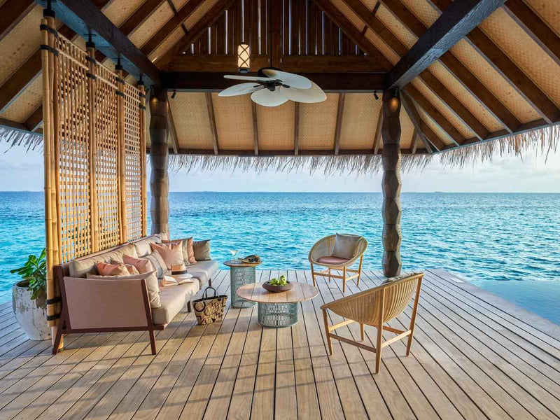The outdoor living area of a Luxury Sunset Water Villa with Pool at JOALI Maldives.