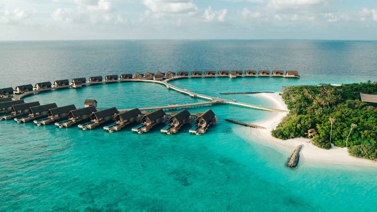 JOALI BEING, Bodufushi from the air, overwater villas curving along the beach from the jetty