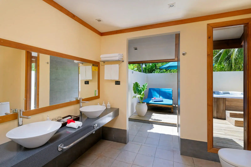 The bathroom of a villa with a private whirlpool at Canareef Resort Maldives