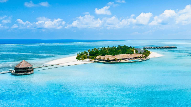 Jawakara Islands Maldives, Lhaviyani Atoll: Dheru island from the air, wooded and ringed by pale shallow water
