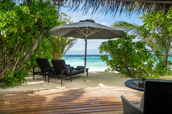 The deck and the beach beyond a Beach Villa at Kandolhu Maldives.