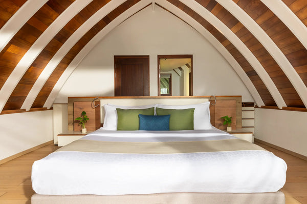 The bedroom in a Duplex Pool Villa at Kandolhu Maldives.