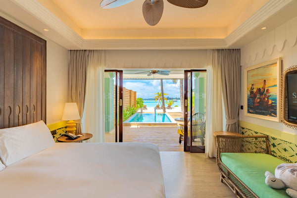 Another view of the bedroom of a Beach Room with Pool at SAii Lagoon Maldives.