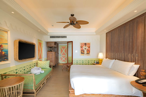 A fourth view of the bedroom of a Sky Room at SAii Lagoon Maldives.