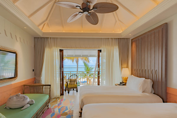 A third view of the bedroom of a Sky Room at SAii Lagoon Maldives.
