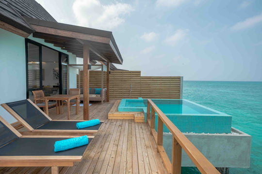 Fushifaru Maldives, Lhaviyani Atoll — a thatched water villa and its deck over the lagoon